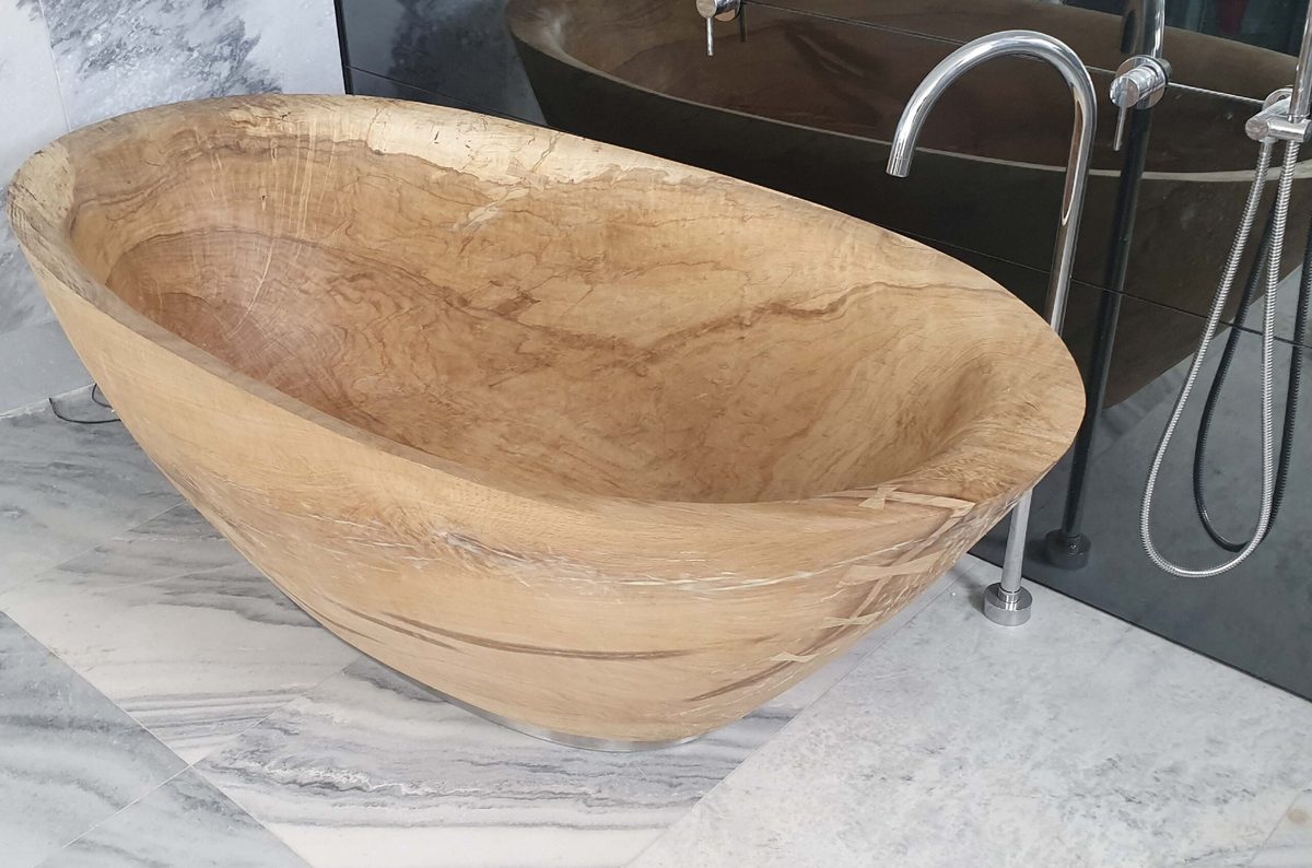 A hand-carved freestanding solid-wood bathtub.